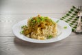 cooked bulgur with meat sauce and vegetables in a plate