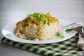 cooked bulgur with meat sauce and vegetables in a plate