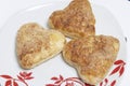 The cooked buns from the puff pastry over the plates.