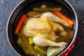 Cooked chicken bouillon of whole chicken in pot Royalty Free Stock Photo