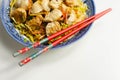 Cooked chicken breast pieces with savory garlic and ginger soy sauce and noodles, black fungus mushrooms, savoy cabbage, and