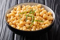 Cooked chickpeas close-up in a black bowl on a table. horizontal background Royalty Free Stock Photo