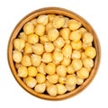 Cooked chickpeas in wooden bowl over white