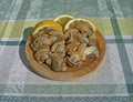 Cooked clams on a wooden plate