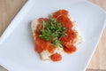 Cooked cod loins with tomato sauce