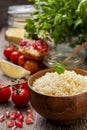 Cooked couscous, fresh vegetables for salad