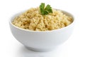 Cooked couscous with green parsley in white ceramic bowl isolate