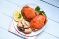 Cooked crab on white plate and wooden background - Seafood boiled red stone crab claw with herb and spices Royalty Free Stock Photo