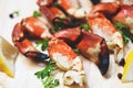 Cooked crabs boiled on wooden board with lemon on plate served seafood - Red stone crab claw Royalty Free Stock Photo