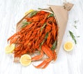 Cooked crayfish and crab claws with lemon are decorated in the form of a bouquet
