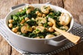 Cooked diet chickpeas with spinach and champignons close-up in a