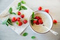 cooked diet oatmeal in a bowl with fresh ripe strawberries