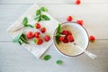 cooked diet oatmeal in a bowl with fresh ripe strawberries