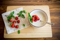 cooked diet oatmeal in a bowl with fresh ripe strawberries