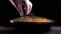 Cooked dish at home in the restaurant the chef decorates the finished pasta dish with grated Parmesan cheese on a kitchen grater