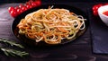 Cooked dish at home in the restaurant the chef decorates the finished pasta dish with grated Parmesan cheese on a kitchen grater