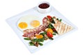 Cooked English breakfast, fried eggs with bacon on square platte Royalty Free Stock Photo