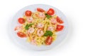 Cooked farfalle pasta with shrimp tails and cherry tomatoes