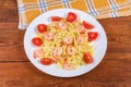 Cooked farfalle pasta with shrimp tails and cherry tomatoes