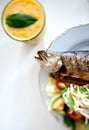 Cooked fish with salad and glass of lemonade Royalty Free Stock Photo