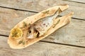 Cooked fish on a wooden plate, top view.