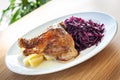 Cooked food - roasted duck leg, red cabbage, potato dumplings. Royalty Free Stock Photo