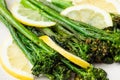 Cooked fresh broccolini with lemon on the plate