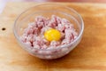 Cooked fresh mince for dish with raw egg lie in a plate