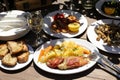 Cooked fresh red scorpionfish, grill shrimps, fried fresh anchovies in the greek tavern, tasty seafood lunch concept. Royalty Free Stock Photo