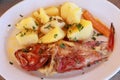 Cooked fresh red scorpionfish sarved with boiled potatoes in the greek tavern. Royalty Free Stock Photo