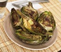 cooked fried halves artichokes on brown plate Royalty Free Stock Photo