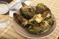 Cooked fried halves artichokes on brown plate Royalty Free Stock Photo