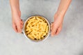 Cooked fusilli pasta in a sieve or strainer, italian food ingredients, hands holding colander Royalty Free Stock Photo