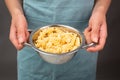 Cooked fusilli pasta in a sieve or strainer, italian food ingredients, hands holding colander Royalty Free Stock Photo