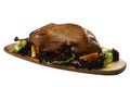 Cooked goose on a wooden board.