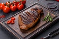 Cooked grilled Chuck eye roll steak on a chopping Board Royalty Free Stock Photo