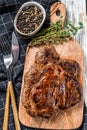 Cooked grilled Chuck eye roll steak on a chopping Board. White background. Top view Royalty Free Stock Photo