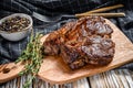 Cooked grilled Chuck eye roll steak on a chopping Board. White background. Top view Royalty Free Stock Photo