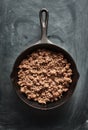 Cooked ground beef in cast iron skillet flat lay composition