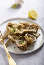 Cooked Italian Artichokes on the white plate with lemon Royalty Free Stock Photo