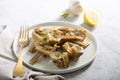 Cooked Italian Artichokes on the white plate with lemon Royalty Free Stock Photo