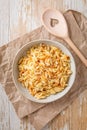 Cooked italian pasta, risoni, orzo in a bowl on wooden table