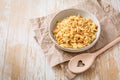 Cooked italian pasta, risoni, orzo in a bowl on wooden table