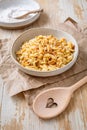 Cooked italian pasta, risoni, orzo in a bowl on wooden table