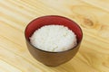 Cooked jasmine rice in white bowl on wooden table and dark background with copy space,high calories food,Top view Royalty Free Stock Photo