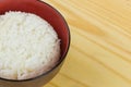 Cooked jasmine rice in white bowl on wooden table and dark background with copy space,high calories food,Top view Royalty Free Stock Photo