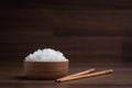 Cooked jasmine rice in wooden bowl with chopsticks on wooden table. Thai Jasmine rice Royalty Free Stock Photo