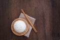 Cooked jasmine rice in wooden plate with chopsticks and sackcloth on wooden table. Thai Jasmine rice Royalty Free Stock Photo