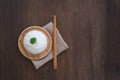 Cooked jasmine rice in wooden plate with chopsticks and sackcloth on wooden table. Thai Jasmine rice Royalty Free Stock Photo