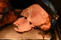 Succulent cooked roast gammon with chef hand and carving knife Royalty Free Stock Photo